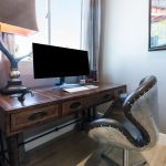 Room inside house with desk, chair, and computer