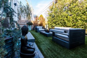 House backyard with couch and statues